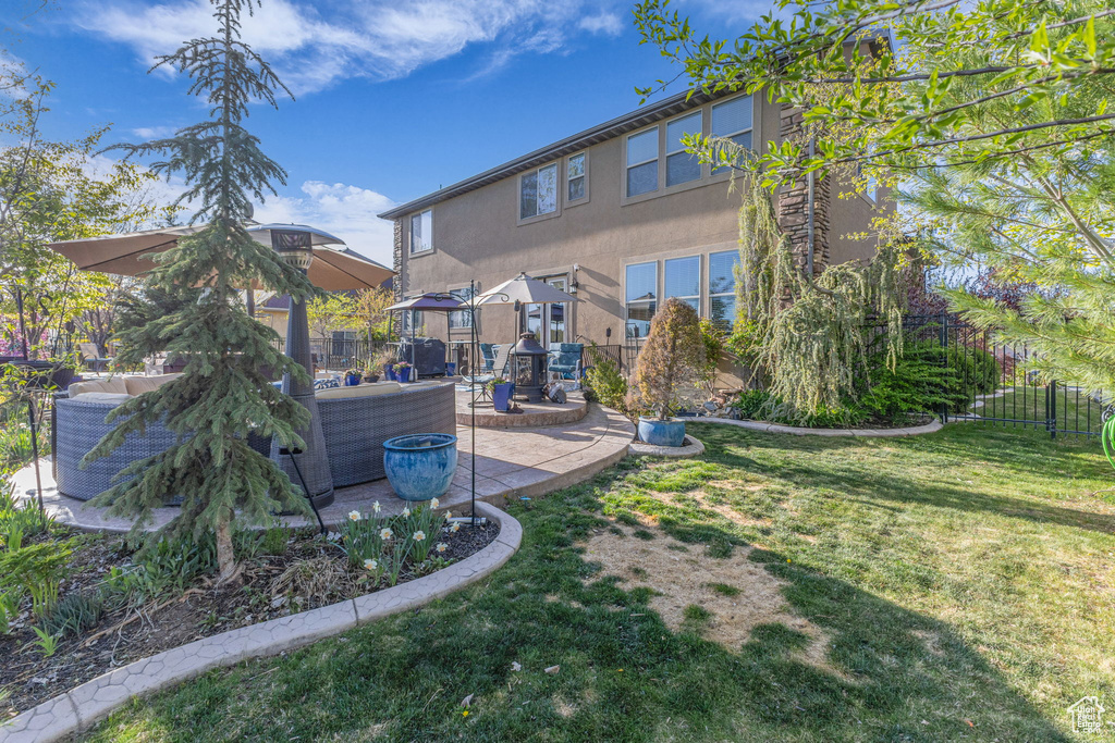 Back of house with a patio, stucco siding, and an outdoor hangout area