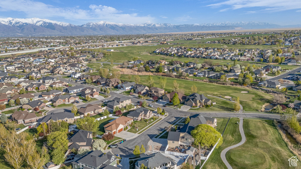 Aerial overview of property's location with nearby suburban area, mountains, and a golf club