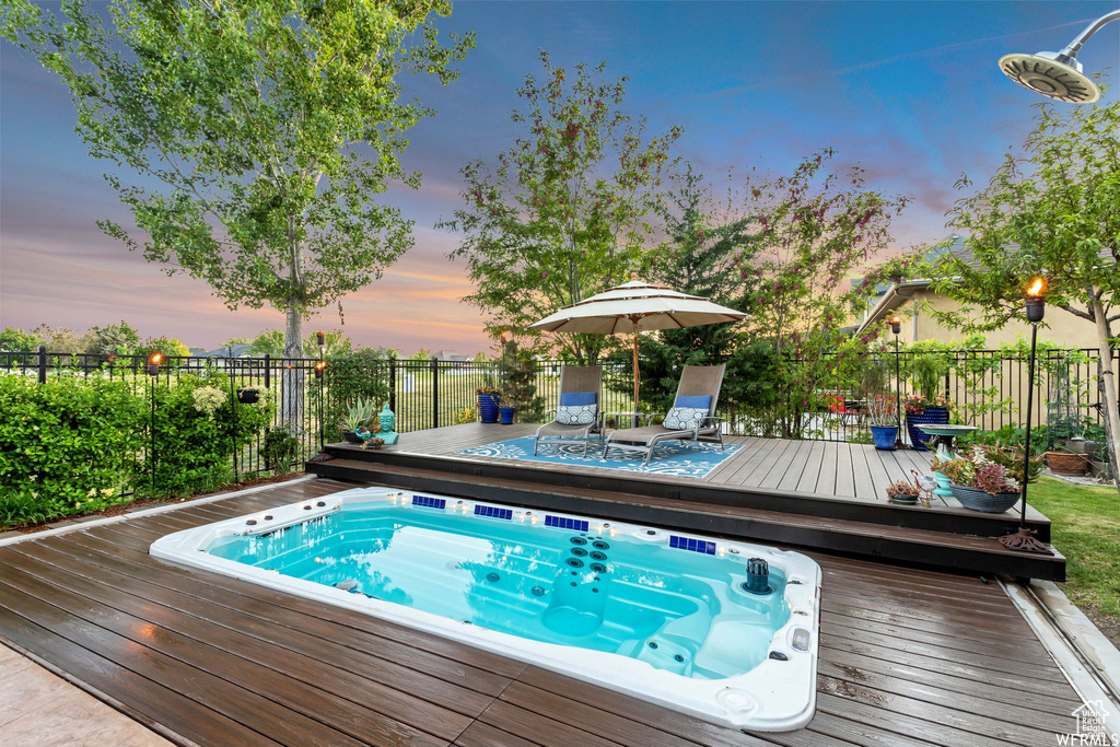 View of swimming pool with a wooden deck