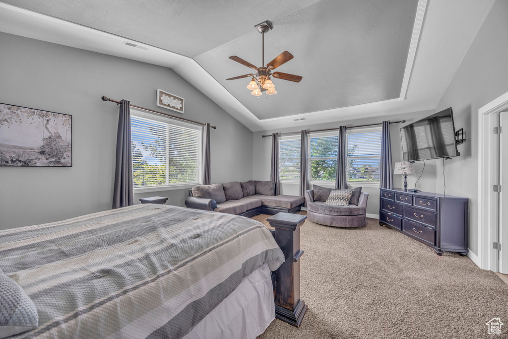 Bedroom featuring carpet, vaulted ceiling, and ceiling fan
