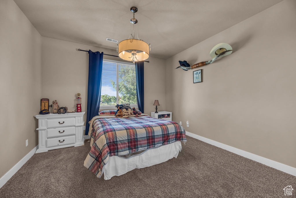 Bedroom featuring carpet floors and baseboards