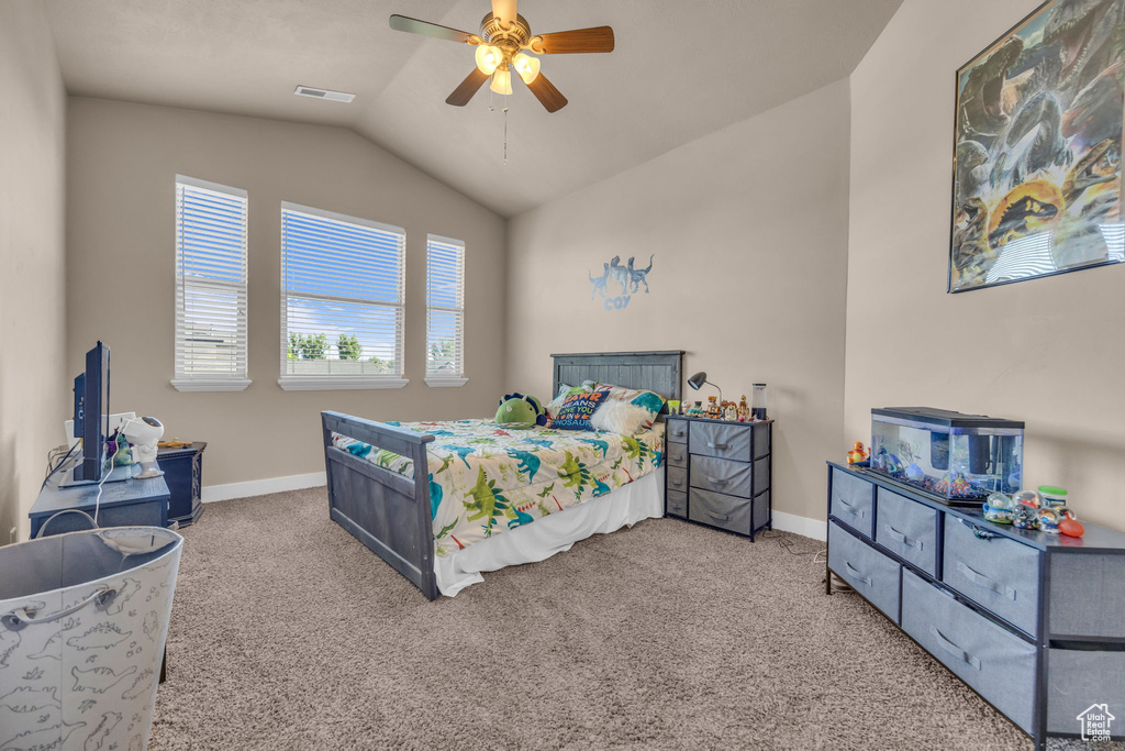 Bedroom with vaulted ceiling, carpet, baseboards, and ceiling fan