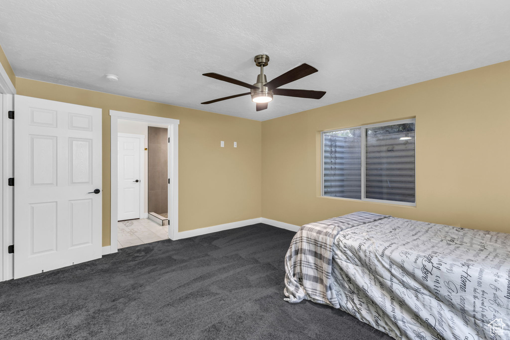 Bedroom with carpet, baseboards, and ceiling fan
