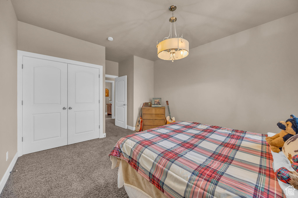 Bedroom featuring carpet floors, a closet, and baseboards