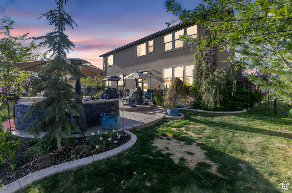 Back of house with a patio area and stucco siding