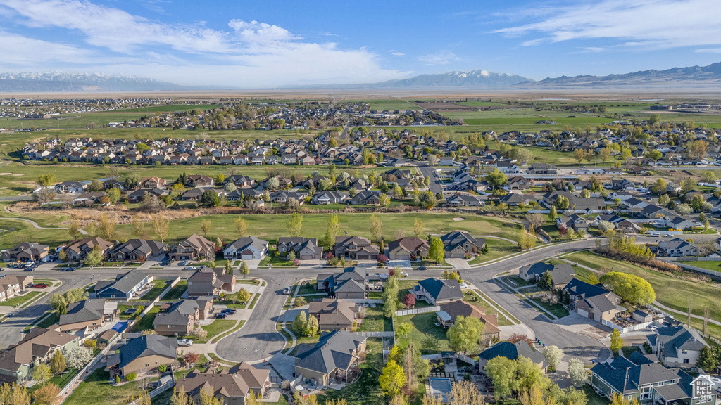 Aerial overview of property's location featuring a mountain backdrop and nearby suburban area