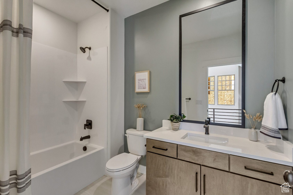 Full bath featuring shower / tub combo, toilet, and vanity