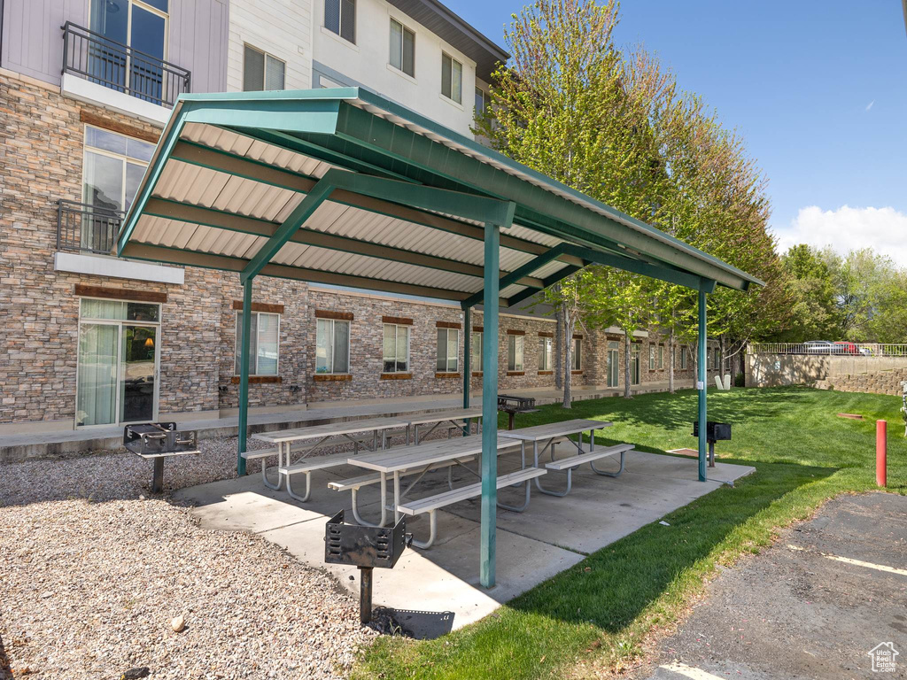 View of property\'s community with fence, a gazebo, a yard, and a patio area