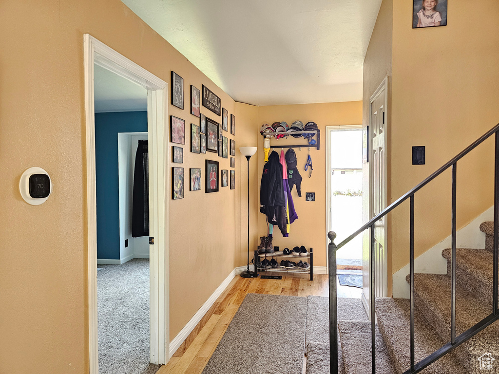 Interior space featuring light wood finished floors, stairs, and baseboards