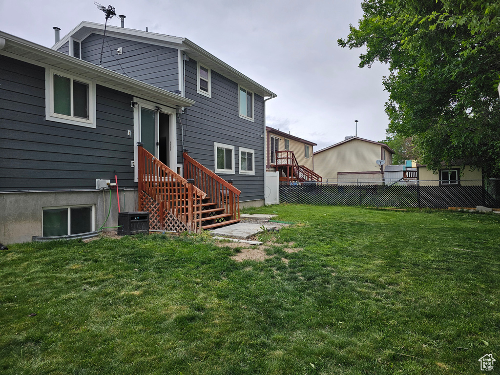 Rear view of house with central AC unit