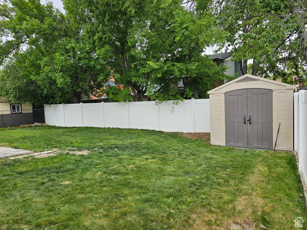 View of yard with a shed and an outbuilding