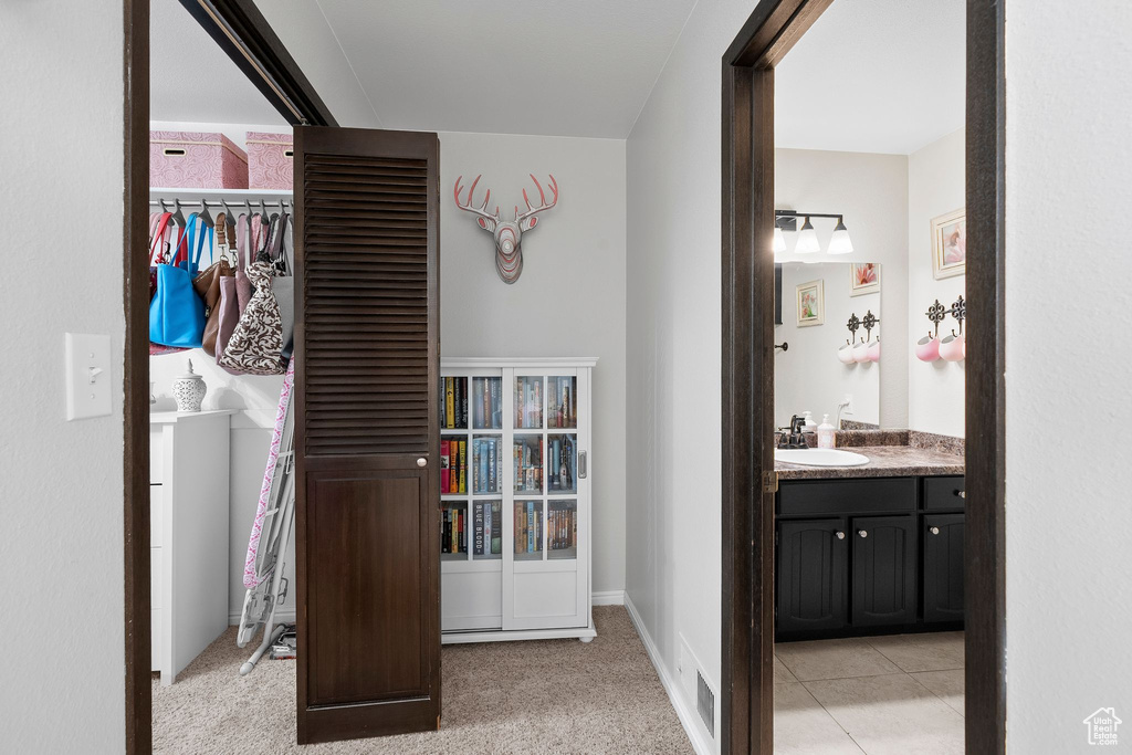 Hall featuring a sink and visible vents
