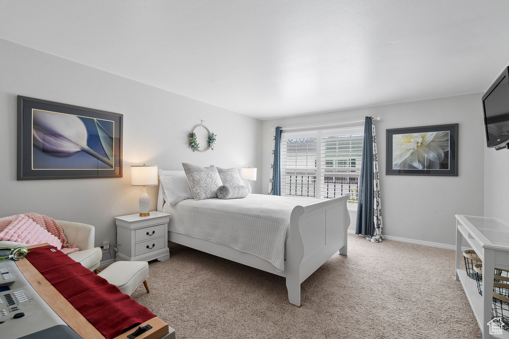Bedroom featuring carpet floors and baseboards