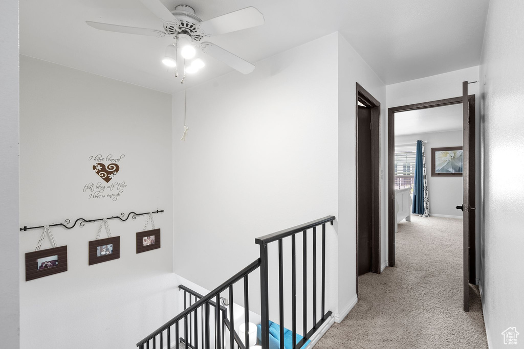 Hall with carpet and an upstairs landing