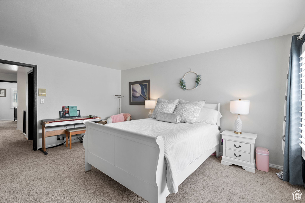Bedroom featuring light colored carpet