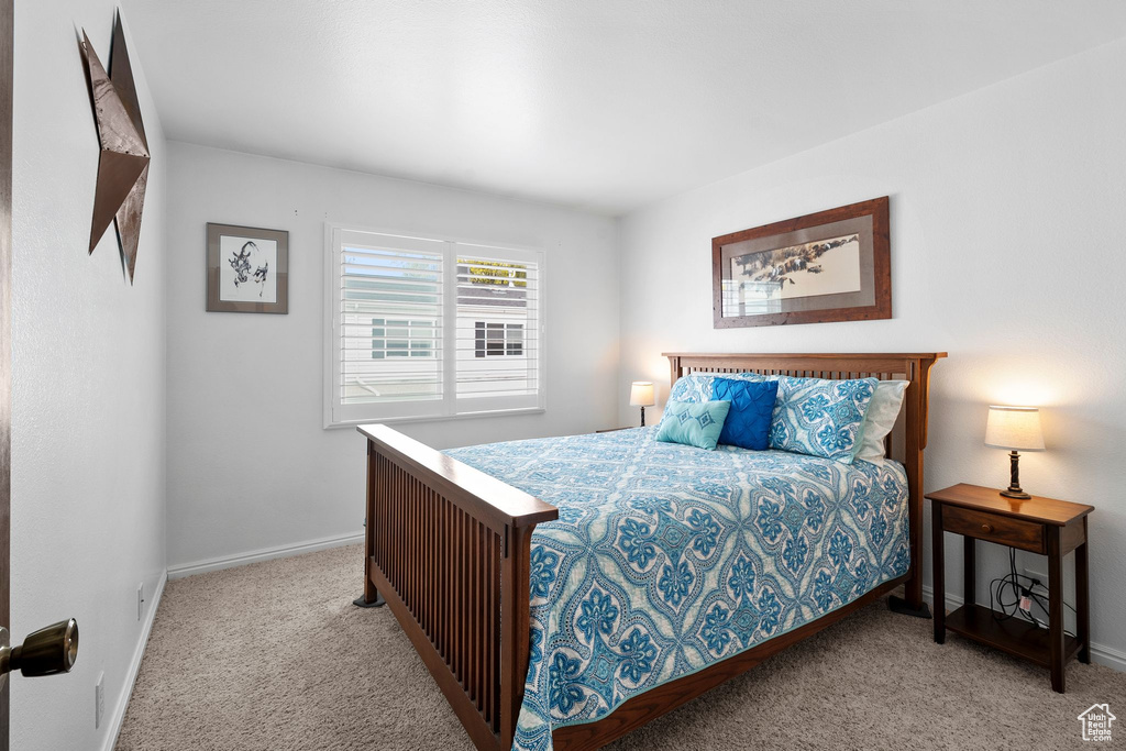 Bedroom featuring carpet floors and baseboards
