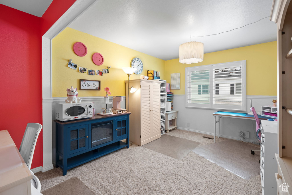 Interior space featuring a wainscoted wall and carpet floors