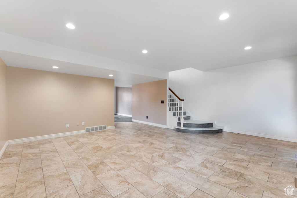 Interior space with baseboards, visible vents, recessed lighting, and stairs