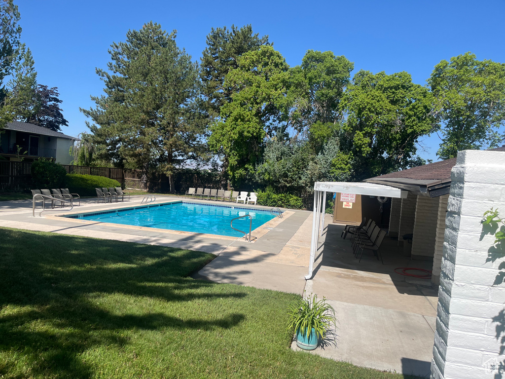 Community pool with a patio