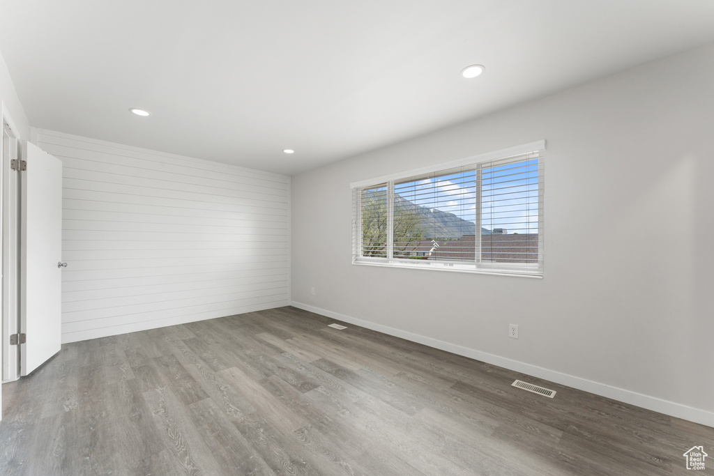 Spare room with baseboards, wood finished floors, visible vents, and recessed lighting