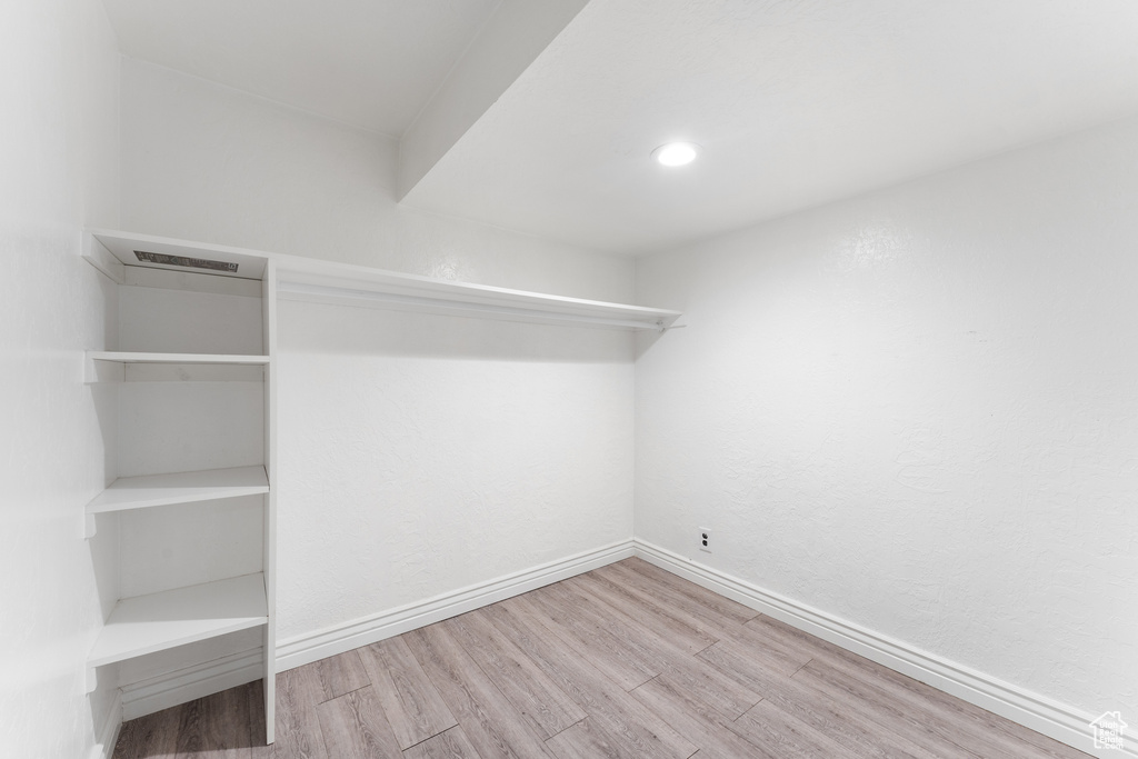 Spacious closet featuring wood finished floors