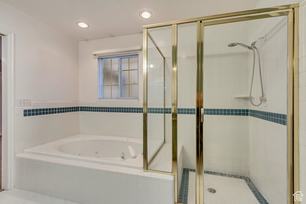 Full bath with a whirlpool tub, recessed lighting, and a stall shower