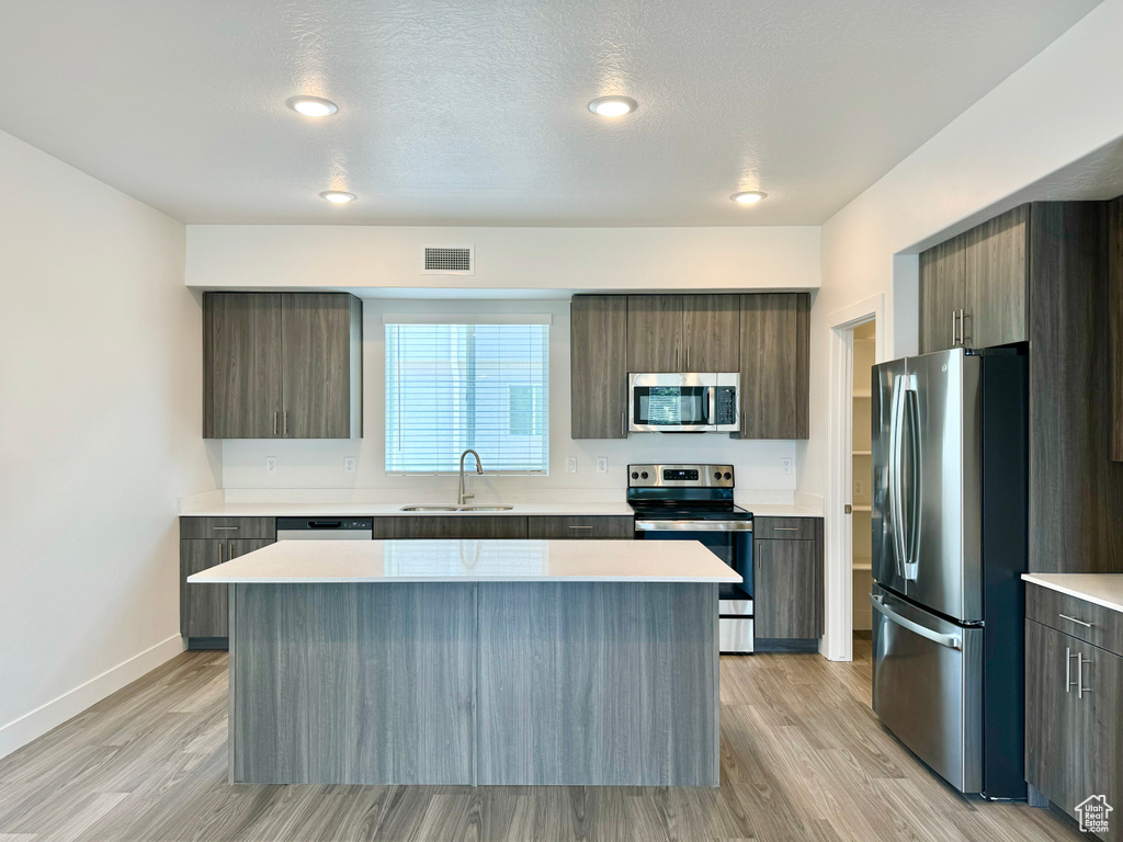 Kitchen with modern cabinets, visible vents, stainless steel appliances, and a sink