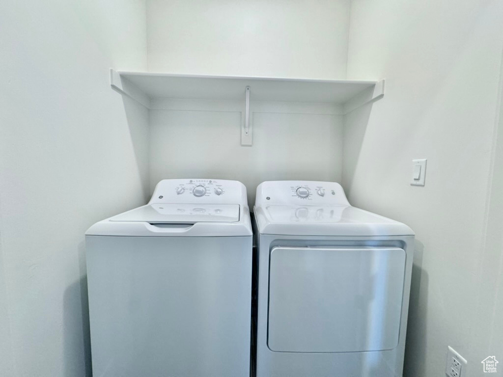 Clothes washing area featuring washer and clothes dryer and laundry area