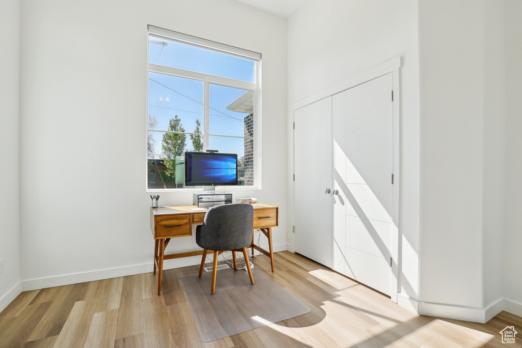 Home office with baseboards and light wood-style floors