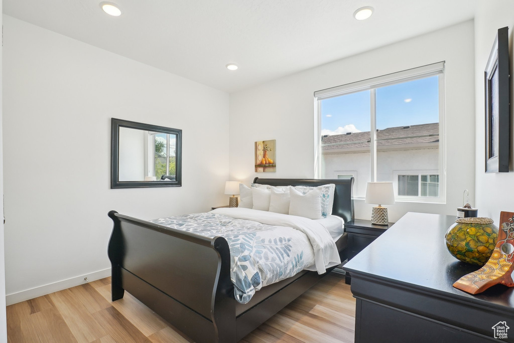 Bedroom featuring recessed lighting, light wood-style flooring, and baseboards