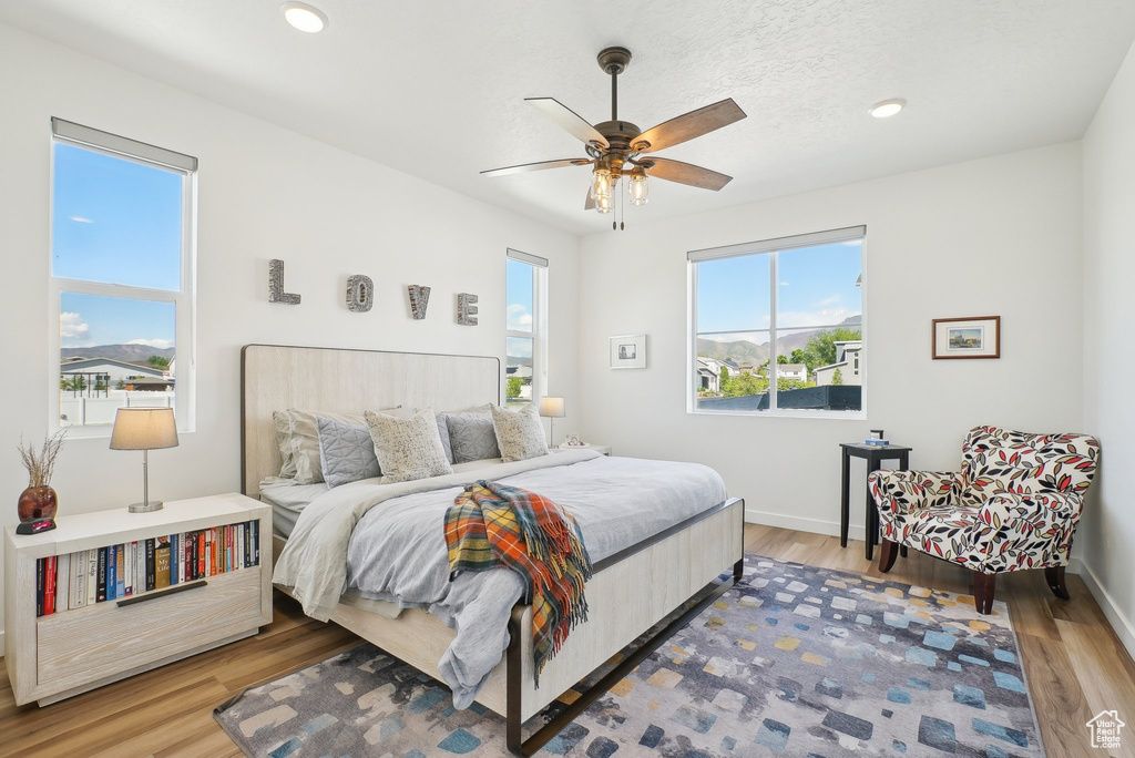 Bedroom featuring a ceiling fan, baseboards, and wood finished floors