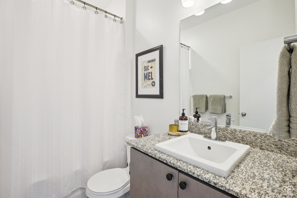 Full bath featuring toilet and vanity