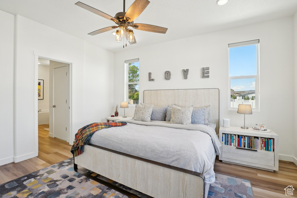 Bedroom featuring baseboards, ceiling fan, and wood finished floors