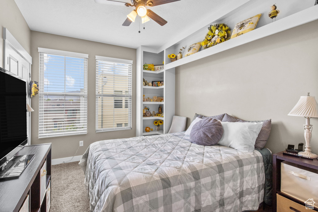 Bedroom featuring carpet floors, a ceiling fan, and baseboards