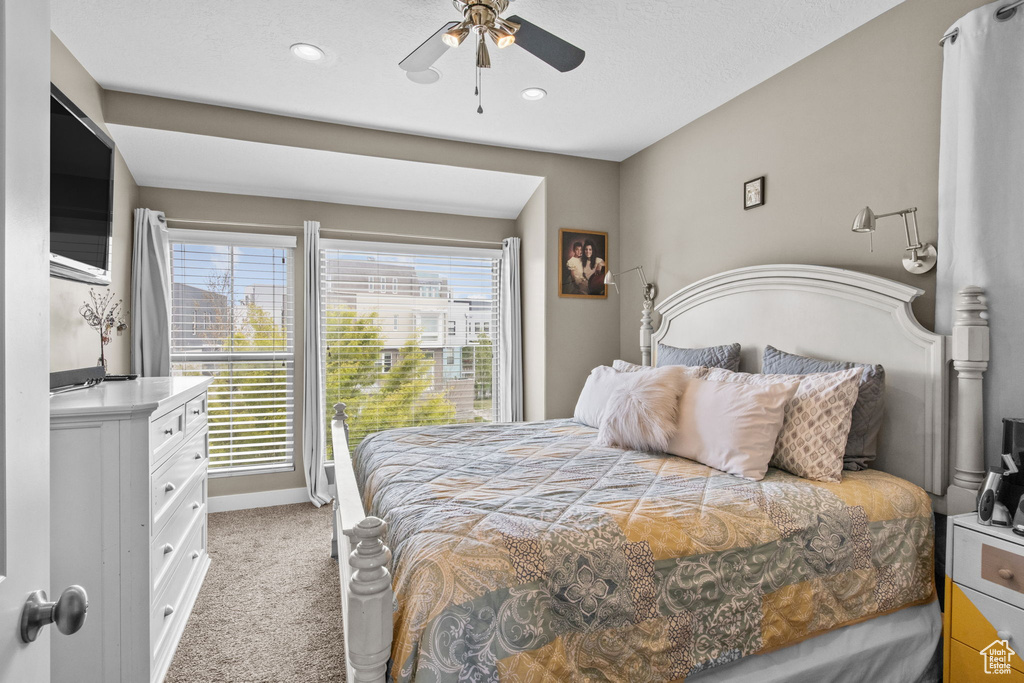 Bedroom with ceiling fan, baseboards, recessed lighting, and light colored carpet