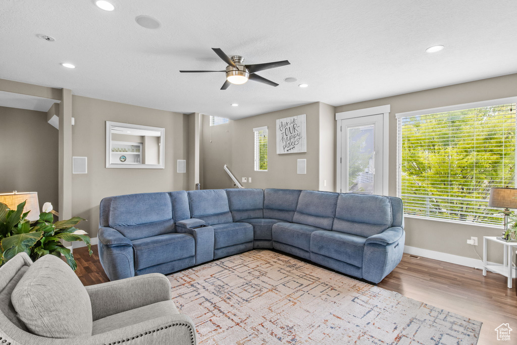 Living area featuring recessed lighting, ceiling fan, a wealth of natural light, and baseboards