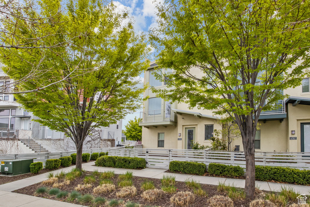 View of front of property with a fenced front yard and stucco siding