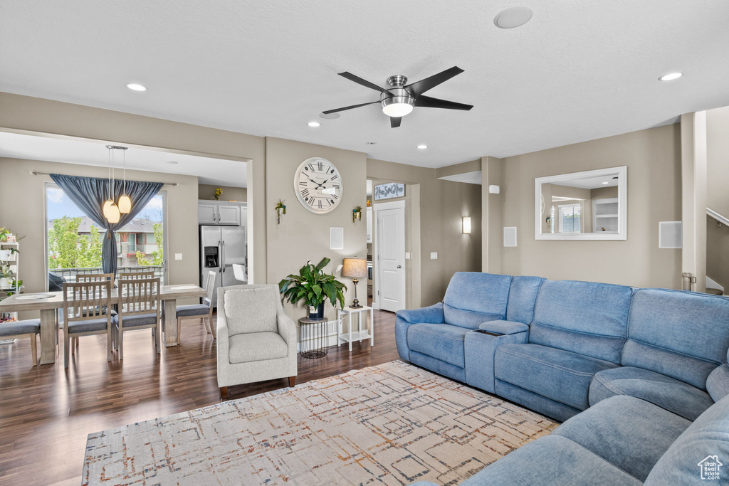 Living room featuring recessed lighting, dark wood-style floors, and ceiling fan