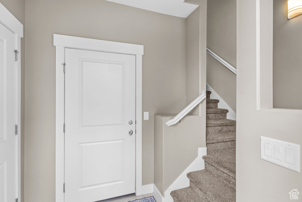 Entrance foyer with baseboards and stairs