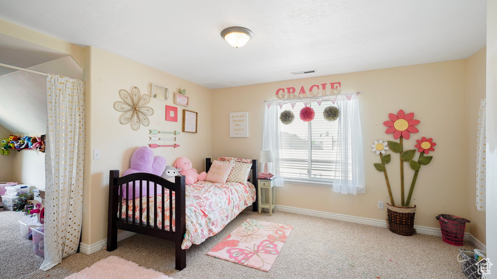 Carpeted bedroom with baseboards and visible vents