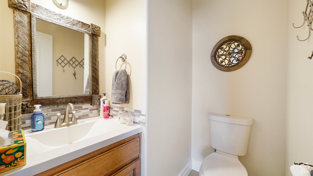Half bathroom featuring toilet and vanity