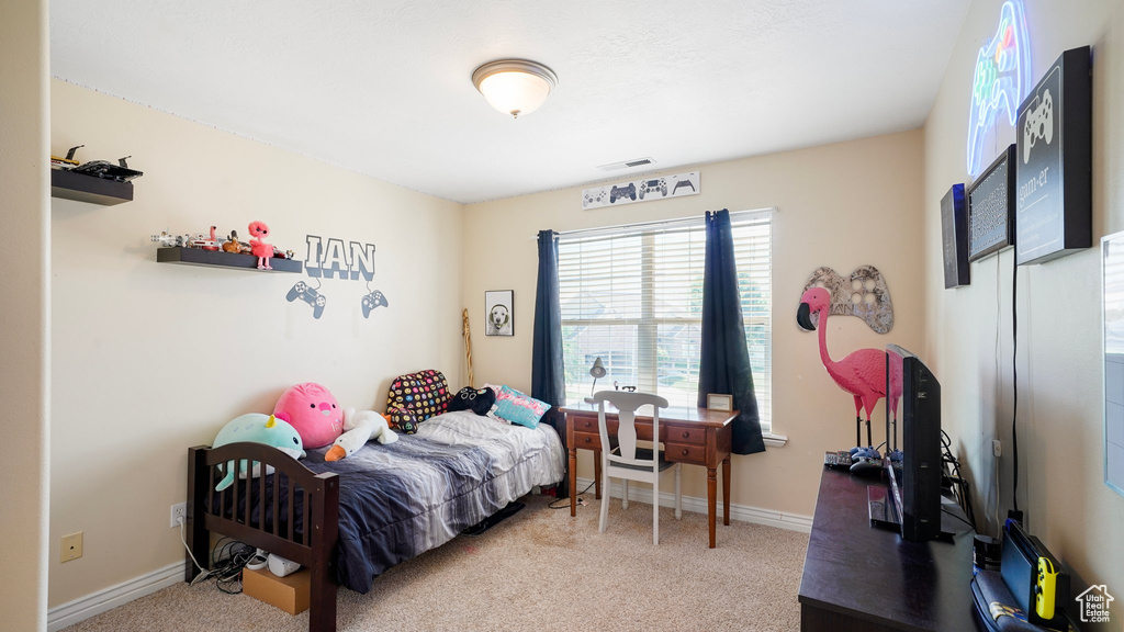 Bedroom with carpet floors, visible vents, and baseboards