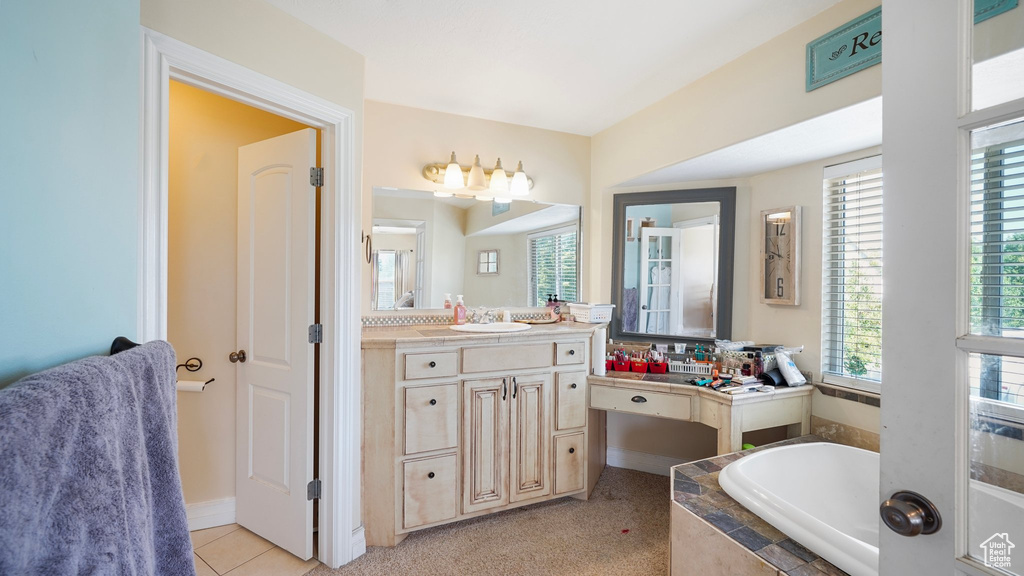Full bathroom featuring a garden tub and vanity