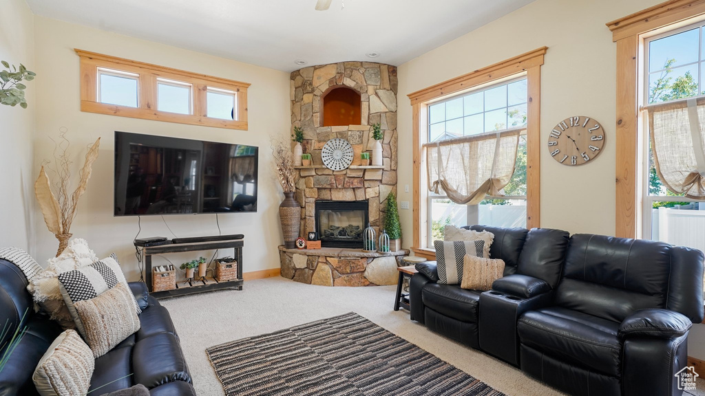 Carpeted living area with a healthy amount of sunlight and a fireplace