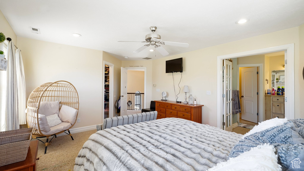 Carpeted bedroom with recessed lighting, visible vents, a walk in closet, baseboards, and ceiling fan