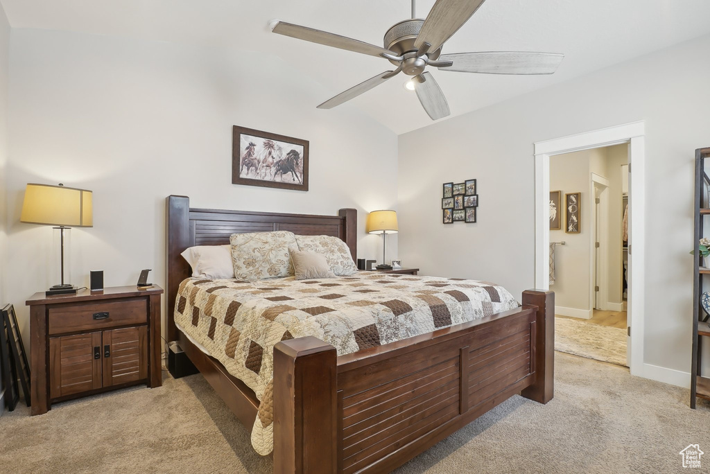 Bedroom featuring baseboards, light carpet, and ceiling fan