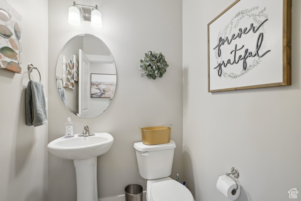 Bathroom with toilet and baseboards