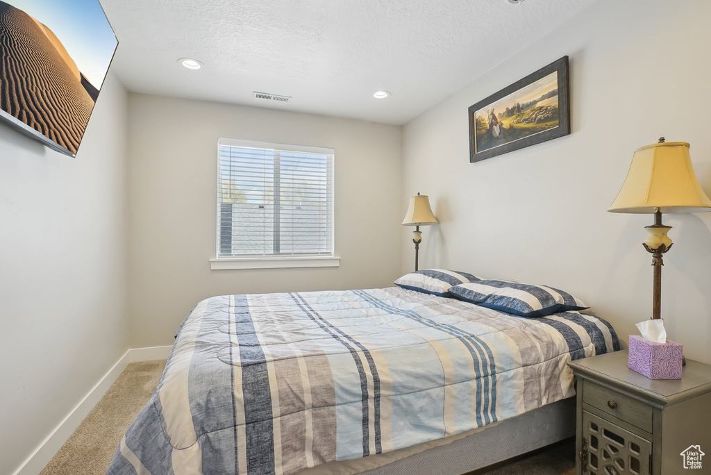 Bedroom with recessed lighting, visible vents, carpet, baseboards, and a textured ceiling