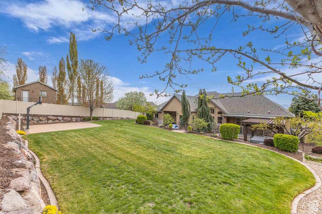 View of yard featuring a fenced backyard and a patio