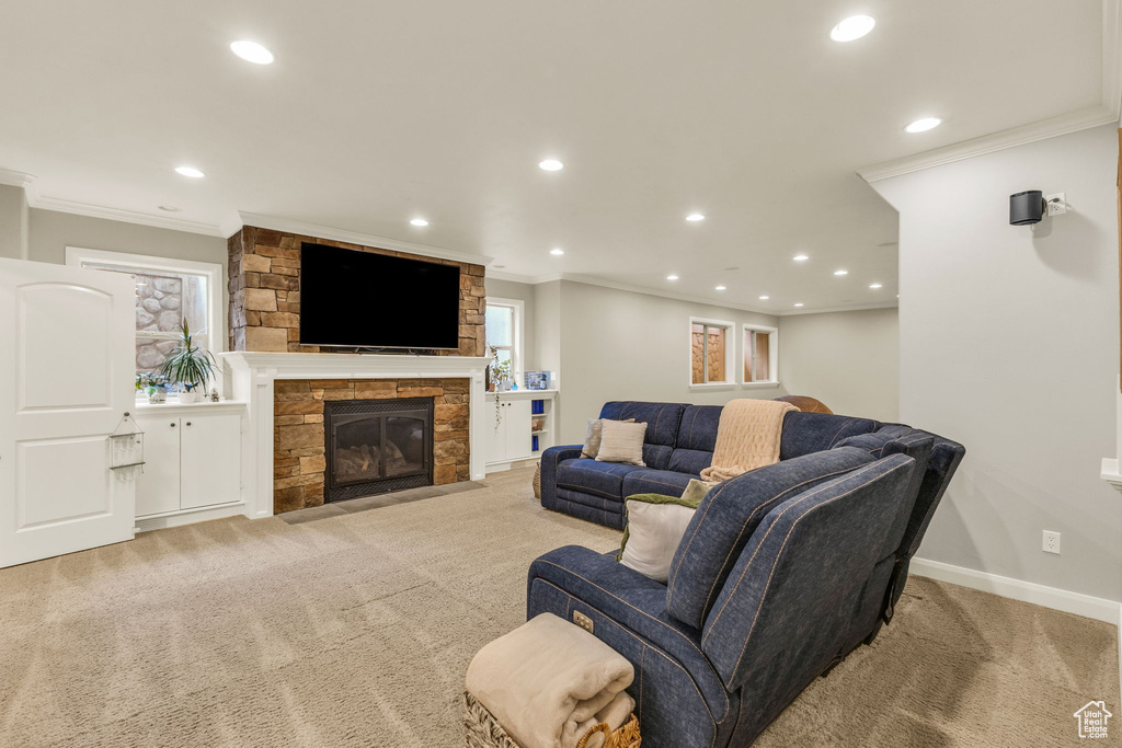 Living room with carpet floors, ornamental molding, and recessed lighting